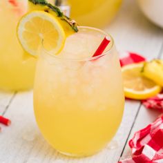 two glasses filled with lemonade sitting on top of a table