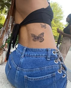 a woman with a butterfly tattoo on her lower back and side view of her stomach