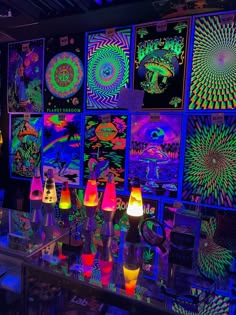 a room filled with lots of different colored lights and posters on the wall behind it