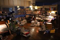 a room filled with lots of books on top of a wooden floor