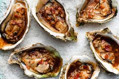 several oysters on ice with sauce and seasoning