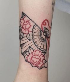 a woman's arm with a tattoo on it and a fan in the middle