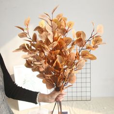 a woman holding a bouquet of flowers in her hands