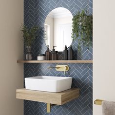 a bathroom sink sitting under a mirror next to a shelf