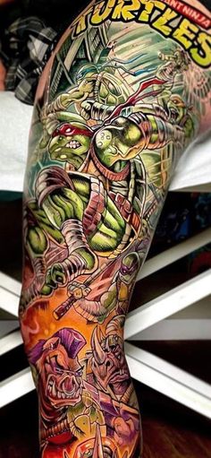 the back of a man's leg with tattoos on it and an image of a creature