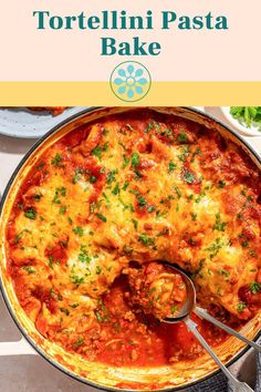 tortellini pasta bake in a pan with a serving spoon on the side