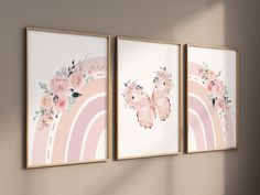 three framed paintings on the wall with flowers and a butterfly in front of a rainbow