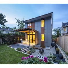 a modern house in the middle of a yard