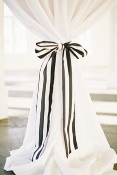 black and white ribbon tied to the back of a chair