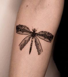 a black and white photo of a dragonfly tattoo