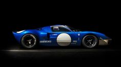 a blue and white race car in the dark