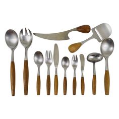 an assortment of spoons and forks with wooden handles