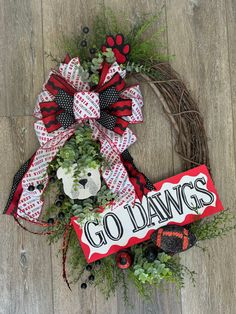 a wreath with the words go wall go on it and a bear head is attached