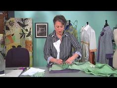 a woman is sewing clothes on a table