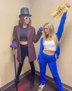 two women dressed in costumes posing for the camera, one holding up a sign that says golden ticket