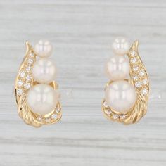 Gemstone Information: - Natural Cultured Pearls - Size - 4.1, 5.5, 6.6 - 6.7 mm Cut - Round Bead Shape Color - White - Natural Diamonds - Total Carats - 0.18ctw Cut - Round Brilliant Color - E - F Clarity - VS2 Metal: 18k Yellow Gold Weight: 5.5 Grams  Stamps: 18k Closure: Stick Posts & Butterfly Backs Measurements: 18.8 x 9.6 mm Each piece is thoroughly examined and refinished as needed by our professional jewelers, graded by our in-house GIA (Gemological Institute of America) Graduate Gemologi Mens Custom Jewelry, Pearl Diamond Earrings, Pearl And Diamond Earrings, Recycled Jewelry, Message Jewelry, Pearl Gemstone, Pearl Diamond, Fine Jewellery Earrings, Pearl Size