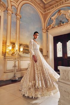 This jacket lehenga set features intricate pearl embroidery interspersed with delicate cut work on a nude base. The full sleeve jacket shows pearl tassels at sleeve hem and is paired with matching embroidered lehenga. The scalloped dupatta shows pearl drops.From Seema Gujral's Falaknuma collection. DELIVERY TIMEPlease allow 8-12 weeks for your outfit to arrive. FABRIC DETAILSNet Professional cleaning only. Anarkali Sets With Pearl Embroidery In Cream, Embellished Beige Anarkali Sets, Cream Embellished Anarkali Set, Anarkali Cream Sharara With Pearl Embroidery, Beige Embellished Anarkali Sets, Elegant Off White Festive Gown, Elegant Off-white Festive Gown, Festive Cream Anarkali Set With Pearl Embroidery, Elegant Off White Gown For Festive Occasions