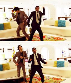 two men in suits are dancing on the floor