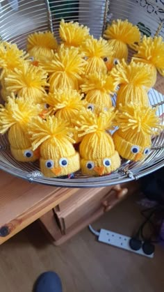 some yellow stuffed animals in a metal bowl