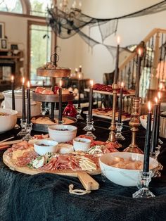 a table topped with lots of food and candles