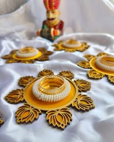 an elaborately decorated table with gold and white dishes on it, including a nutcracker