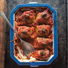 a blue dish filled with meat covered in sauce