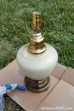 a white lamp sitting on top of a cardboard box