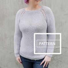 a woman standing in front of a wall wearing a gray sweater and jeans with the words pattern on it