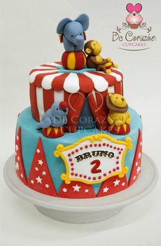 a circus themed birthday cake with animals on top