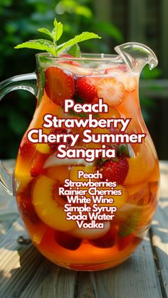 a pitcher filled with fruit sitting on top of a wooden table