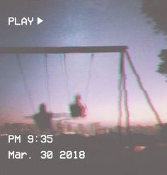 blurry image of two people on a swing set at dusk with text overlay