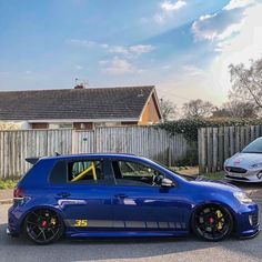 a blue car parked in front of a house