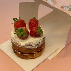 there is a cake with strawberries on top