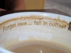 a coffee cup with the words forget love, fall in coffee written on it's rim