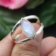 Elevate your style with our stunning Rainbow Moonstone ring. This handcrafted beauty features a mesmerizing Rainbow Moonstone set in a splendid sterling silver ring. *Captivating Colors: The Rainbow Moonstone's iridescent play of colours adds a touch of magic to your look. Each stone is carefully chosen for its unique charm. *Celestial Charm: The sterling silver moonstone setting adds a celestial touch, showcasing the moonstone in an elegant and timeless design. *Handcrafted Beauty: made by skilled artisans, each ring is a work of art that brings a special touch to your style. *Versatile Elegance: Whether for special occasions or everyday wear, this Moonstone ring is a versatile piece that adds a hint of mystique to any outfit. *Perfect Fit: Available in various sizes, ensuring a comfortab Unique Moonstone Rings With Gemstone Accents, Moonstone Rings With Natural Stones, White Moonstone Rings With Gemstone Accents, Silver Jewelry With Gemstone Accents In Marquise Shape, Silver Marquise Jewelry With Gemstone Accents, Silver Jewelry With Marquise Gemstone Accents, Moonstone Rings With Natural Stones, Open Design, Moonstone Gemstone Open Ring Jewelry, Moonstone Marquise Jewelry As A Gift