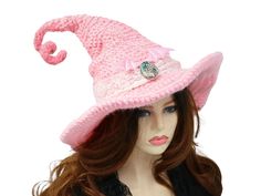 Ready for the Renfaire, a festival, cosplay, a pagan celebration, your table centerpiece, this pink bat wing witch hat is ready for the occasion. Firmly structured but soft to wear, you can shape this hat just about any way you like because both the tip and the brim are wired. I crocheted this in a an ombre of pink shades, dark at the top to light at the edge of the brim.  A real abalone cabochon rests at the front with a cream colored stretchy lace hat band. Pink luster bat wings rest above the cabochon, for that extra pretty touch of witchy. Twist up that tip any way you like and let the hat do the talking. When you're not wearing it, you can toss it on your table for a great conversational centerpiece, or hang it on a hook by the door! Folds flat for travel. -This soft witchy hat has so Themed Curved Brim Hats For Costume Party, Themed Hats With Curved Brim For Costume Party, Whimsical High Crown Hat For Themed Events, Themed High Crown Costume Hats For Cosplay, Themed Mini Hat With Curved Brim For Costumes, Gothic Brimmed Mini Hat For Cosplay, Brimmed Costume Hats And Headpieces, Curved Brim Costume Hat For Carnival, Pink Costume Hats And Headpieces For Halloween