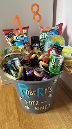 a bucket filled with candy and candies on top of a wooden floor