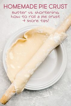 a piece of bread sitting on top of a white plate next to a wooden stick