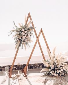 an outdoor ceremony setup with flowers and greenery