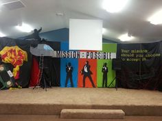 the stage is set up for an upcoming musical performance with posters and microphones on it