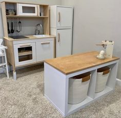 a kitchen with white appliances and wooden counter tops in the middle of carpeted flooring