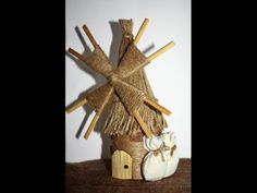 a small house made out of straw and wood sticks