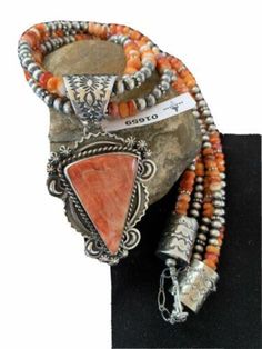 Masha Indian Native American Jewelry -On Route 66 - Albuquerque, New Mexico U.S.A Item Specifics           * Stone : Spiny Oyster * Size : 20" * Strands : 3 * Pendant Size : 1.75" x 2.50" * Color : Red * Artisan : Harold Joe * Free gift with Purchases (Till Stocks Last) Genuine Sterling Silver Jewelry This beautiful Necklace is made from all 925 Sterling Silver Beads and Findings.  These Beads are meticulously hand strung and assembled by the artist creating the perfect balance of fall, color and shine. Necklaces are a must have for any collection, whether you are just starting out or are a serious collector you will not be disappointed with this work of art. These necklaces have excellent fall and can even be stacked with others, fashioned with a pendant or worn double wrapped to give you New Mexico Usa, Albuquerque New Mexico, Native American Artists, Spiny Oyster, Multi Strand Necklace, Route 66, Native American Jewelry, Sterling Silver Bead, Multi Strand