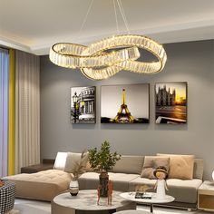 a living room filled with furniture and a chandelier hanging over the top of it