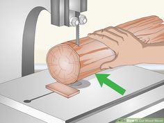 a piece of wood being worked on by a machine with an arrow pointing to it