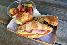 a sandwich and fruit salad on a tray