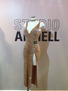 a dress on display in front of a studio sign with the name stella angeloi