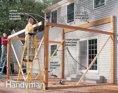 two men working on the framing of a house