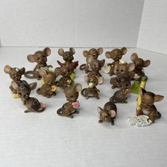 a group of small figurines sitting on top of a white table next to each other