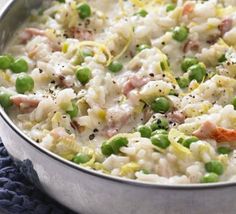 a pot filled with rice and peas on top of a table